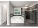 Renovated main bath boasts a tiled walk-in shower, soaking tub, and tiled floors at 2994 Meadow Church Rd, Suwanee, GA 30024