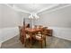 Formal dining room featuring wainscoting, a modern chandelier, and views to backyard at 2994 Meadow Church Rd, Suwanee, GA 30024