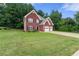 Beautiful brick home with a lush green lawn and attached two car garage at 2994 Meadow Church Rd, Suwanee, GA 30024