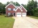 Charming brick home with a two-car garage, manicured lawn, and classic design at 2994 Meadow Church Rd, Suwanee, GA 30024