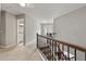 Carpeted hallway showcasing stairwell with decorative wood and wrought iron railing at 2994 Meadow Church Rd, Suwanee, GA 30024