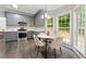 Modern kitchen includes grey cabinets, stainless appliances, and eat in breakfast nook at 2994 Meadow Church Rd, Suwanee, GA 30024