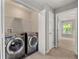 Modern laundry room featuring stainless steel appliances and gray paint at 2994 Meadow Church Rd, Suwanee, GA 30024