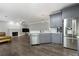 Open concept kitchen view to the living room with fireplace and hardwood flooring at 2994 Meadow Church Rd, Suwanee, GA 30024
