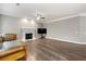 Bright living room boasts a fireplace, ceiling fan, and hardwood floors at 2994 Meadow Church Rd, Suwanee, GA 30024