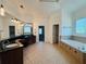 Spacious bathroom includes a soaking tub, double vanity, dark wood cabinets, and separate shower area at 3784 The Great Dr, Atlanta, GA 30349