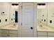 Bathroom with dual sinks, vanity, and lighting above the mirrors at 3784 The Great Dr, Atlanta, GA 30349