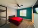 Bedroom showcasing an accent wall, a window, a dark ceiling fan, and neutral carpet at 3784 The Great Dr, Atlanta, GA 30349