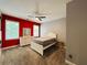 Bedroom featuring a bed, dresser, two windows, and a red accent wall at 3784 The Great Dr, Atlanta, GA 30349