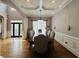 Dining room with wainscoting, hardwood floors and decorative chandelier at 3784 The Great Dr, Atlanta, GA 30349