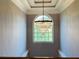 Elegant foyer featuring a tiered chandelier in front of an arched window at 3784 The Great Dr, Atlanta, GA 30349