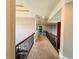 Long hallway with carpet, a wood railing, and ornate trim throughout at 3784 The Great Dr, Atlanta, GA 30349