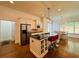 Bright eat-in kitchen boasts white cabinets, stainless appliances, and a breakfast bar with modern lighting fixtures at 3784 The Great Dr, Atlanta, GA 30349