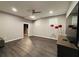 Open-concept living room features a large TV, and modern flooring at 3784 The Great Dr, Atlanta, GA 30349