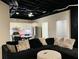 Open-concept living room and kitchen space with dark sofa and stainless steel appliances at 3784 The Great Dr, Atlanta, GA 30349
