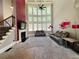 Bright living room with fireplace, large windows, and staircase at 3784 The Great Dr, Atlanta, GA 30349