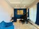 Music room with dark blue walls, carpeted floors, piano, chairs and coffered ceilings at 3784 The Great Dr, Atlanta, GA 30349