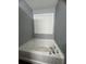 Bathroom featuring a garden tub and a window at 3953 Cress Way Run, Decatur, GA 30034
