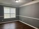 Bright bedroom with wood floors, a window, and neutral gray walls at 3953 Cress Way Run, Decatur, GA 30034
