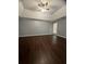A spacious bedroom featuring dark wood floors and a ceiling fan at 3953 Cress Way Run, Decatur, GA 30034