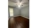 Bedroom featuring wood floors, neutral walls, and a window at 3953 Cress Way Run, Decatur, GA 30034