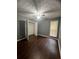 Cozy bedroom features a spacious closet, dark wood floors, and a window with blinds at 3953 Cress Way Run, Decatur, GA 30034