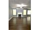 Bright living room with dark wood floors, large windows, fireplace and ceiling fan at 3953 Cress Way Run, Decatur, GA 30034