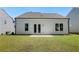 Home exterior featuring a well-maintained lawn and private backyard with a large patio area at 803 Levi Farms Ln, Canton, GA 30115