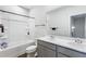 Well-lit bathroom featuring double sinks, modern fixtures, and a combined bathtub and shower at 803 Levi Farms Ln, Canton, GA 30115