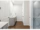 The bathroom features a glass-enclosed shower, dual sink vanity, modern hardware, and wood look flooring at 803 Levi Farms Ln, Canton, GA 30115