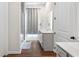 Modern bathroom featuring a glass-enclosed shower, dual sink vanity, and clean white walls at 803 Levi Farms Ln, Canton, GA 30115