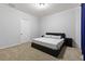 Inviting bedroom featuring a sleek black bed frame, neutral walls, carpet, and ample closet space at 803 Levi Farms Ln, Canton, GA 30115