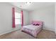 Cozy bedroom featuring neutral walls, a window with pink curtains, and a comfortable single bed at 803 Levi Farms Ln, Canton, GA 30115