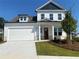 Charming two-story home featuring a classic white exterior and a spacious two car garage at 803 Levi Farms Ln, Canton, GA 30115