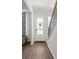 Bright foyer with hardwood floors, a white front door, and a staircase leading to the second floor at 803 Levi Farms Ln, Canton, GA 30115