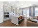 Modern kitchen with stainless steel appliances, white countertops, and seating at the island at 803 Levi Farms Ln, Canton, GA 30115