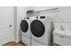 Functional laundry room with modern washer and dryer units, and a utility sink at 803 Levi Farms Ln, Canton, GA 30115