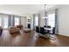 Open-concept living room with a dining area, fireplace, and hardwood floors at 803 Levi Farms Ln, Canton, GA 30115