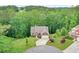 Aerial view of a charming home with a circular driveway, surrounded by lush landscaping and mature trees at 10 Berryhill Se Pl, Cartersville, GA 30121