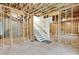 Unfinished basement with framing and staircase offers potential for customization and added living space at 10 Berryhill Se Pl, Cartersville, GA 30121