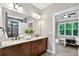 Modern bathroom features double vanity with granite countertops, large mirror, and view into bedroom at 10 Berryhill Se Pl, Cartersville, GA 30121