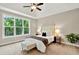 Bright bedroom with a large window showcasing a wooded view at 10 Berryhill Se Pl, Cartersville, GA 30121