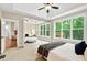 Bedroom featuring a tray ceiling, ceiling fan, and expansive mirrored closet at 10 Berryhill Se Pl, Cartersville, GA 30121