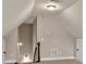 Attic or bonus room with sloped ceilings, window, lighting, carpet, and staircase at 10 Berryhill Se Pl, Cartersville, GA 30121