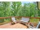 Outdoor deck with seating and a beautiful view of the surrounding trees and greenery at 10 Berryhill Se Pl, Cartersville, GA 30121