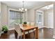 Formal dining room showcasing hardwood floors, natural light, and a stylish chandelier above the wood table at 10 Berryhill Se Pl, Cartersville, GA 30121