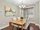 Bright dining room with wood floors, a stylish chandelier, and large window letting in natural light at 10 Berryhill Se Pl, Cartersville, GA 30121