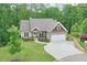 Charming single-Gathering home with a well-manicured lawn, two car garage, and inviting covered porch nestled among mature trees at 10 Berryhill Se Pl, Cartersville, GA 30121