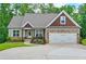 Craftsman style home featuring a two-car garage and a covered porch with beautiful stone and shake accents at 10 Berryhill Se Pl, Cartersville, GA 30121