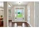 Elegant entryway with gleaming hardwood floors, glass paned door, and view into the bright dining room at 10 Berryhill Se Pl, Cartersville, GA 30121